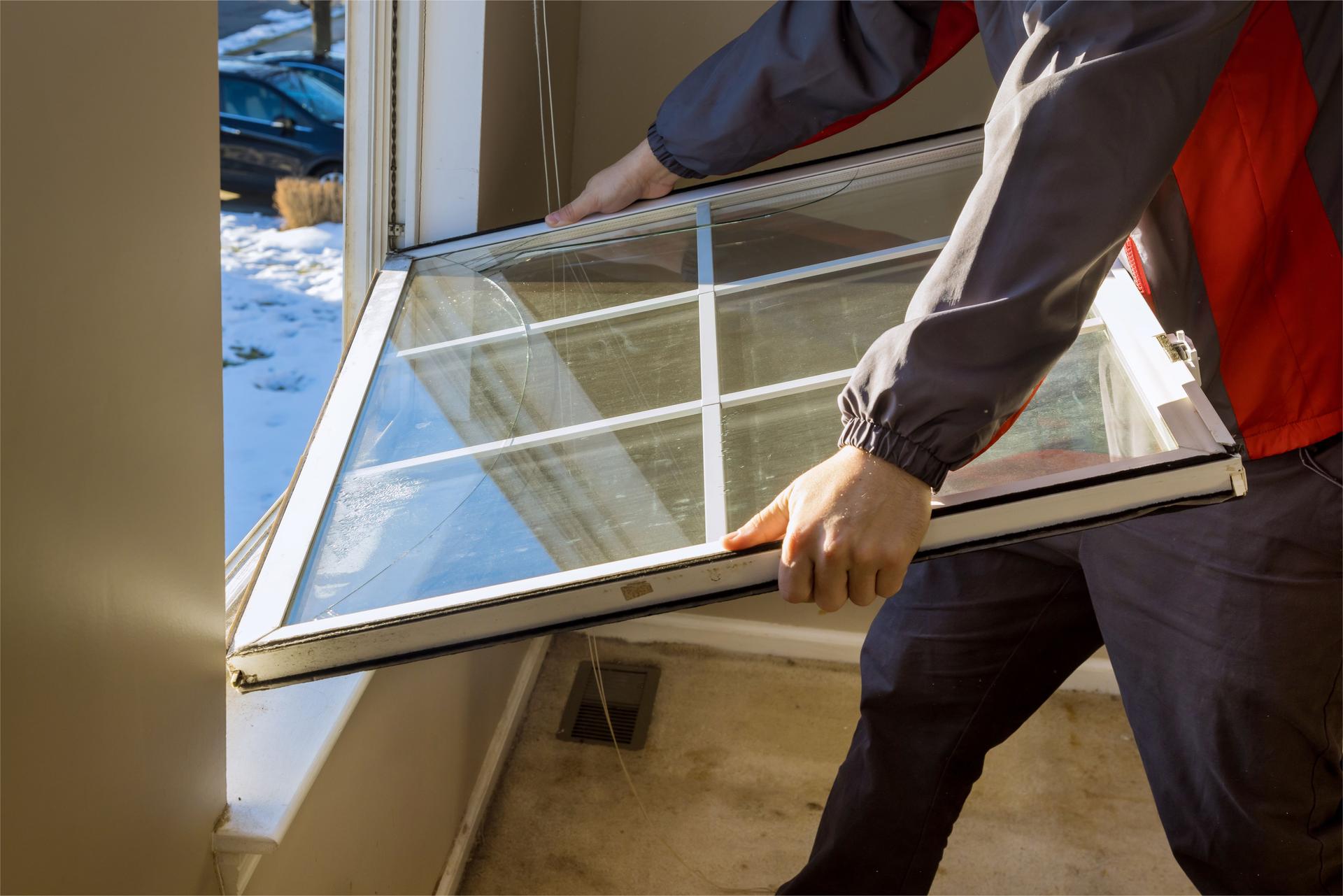Cheerful young man mounting a kitchen window